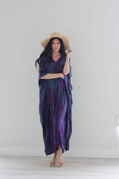 Purple tie-dyed maxi kaftan dress by Erin Pontus featuring a flowing, stylish abaya design with vibrant purple patterns.