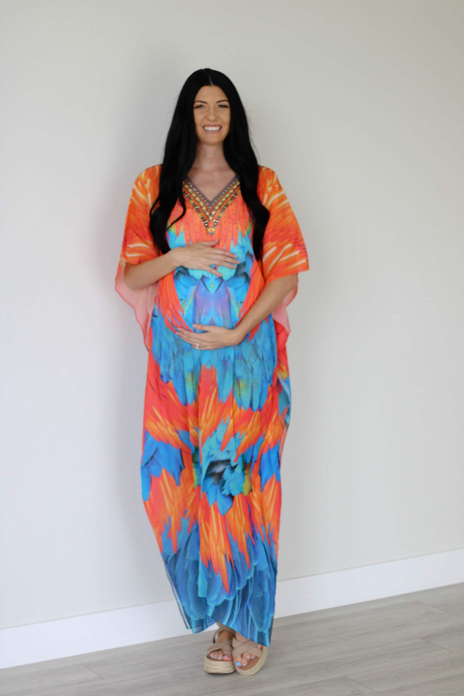 Plus size tribal feather kaftan dress by Erin Pontus featuring vibrant patterns and flowing fabric for a stylish boho look.