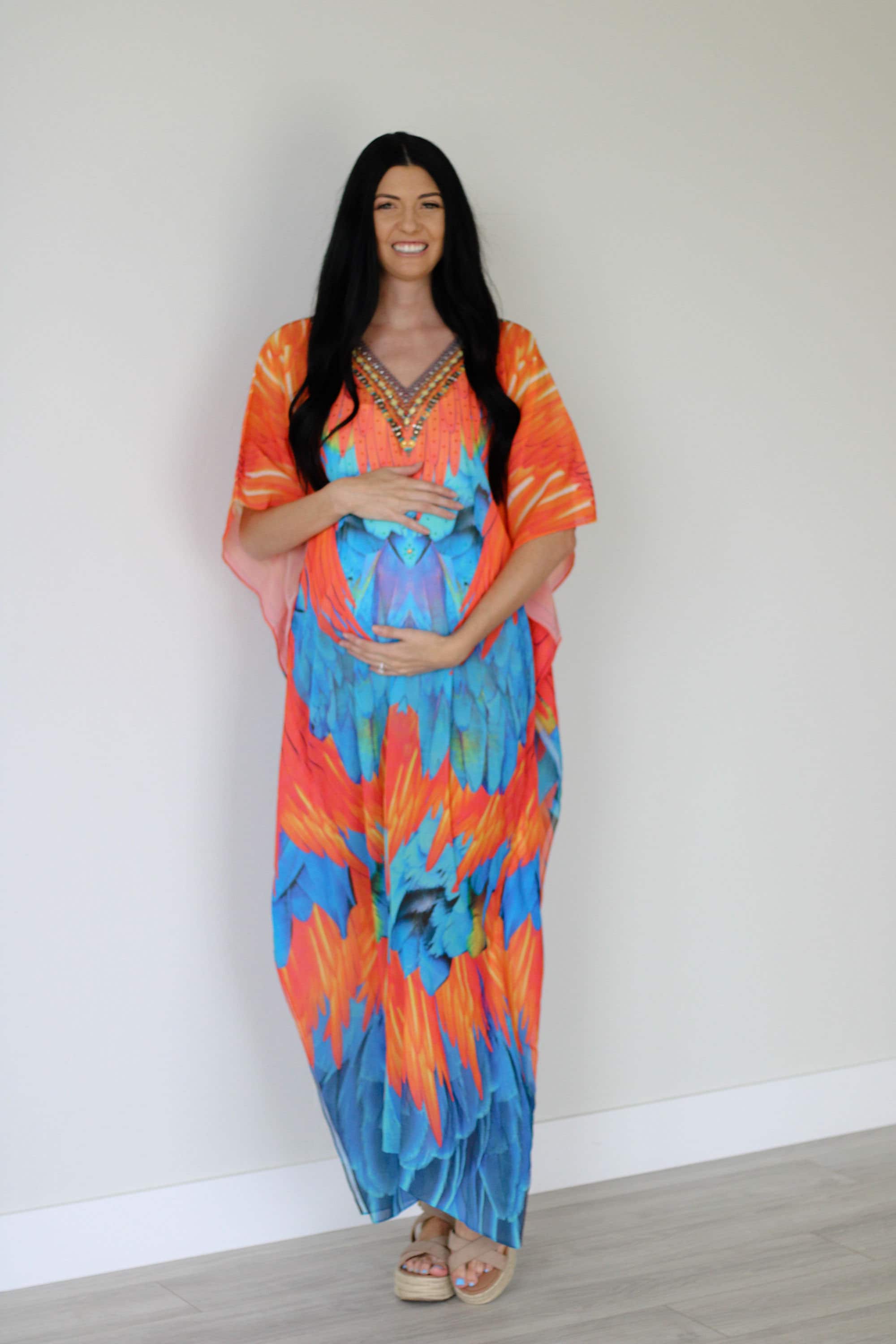 Plus size tribal feather kaftan dress by Erin Pontus featuring vibrant patterns and flowing fabric for a stylish boho look.
