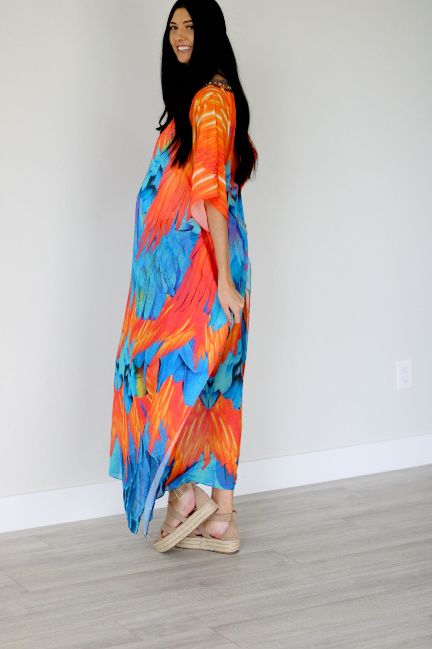 Plus size tribal feather kaftan dress by Erin Pontus featuring vibrant patterns and flowing fabric for a stylish, comfortable look.