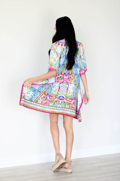 Plus size traditional tribal kaftan dress by Erin Pontus, featuring vibrant patterns and flowing fabric.