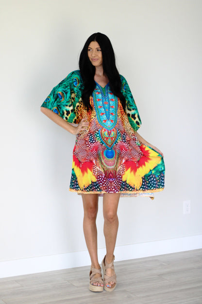 Plus size tropical kaftan dress by Erin Pontus featuring vibrant African-inspired print and a midi length, flowing and stylish.