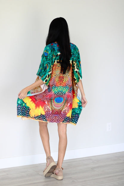 Plus size tropical kaftan dress by Erin Pontus featuring vibrant African-inspired patterns and a midi length.