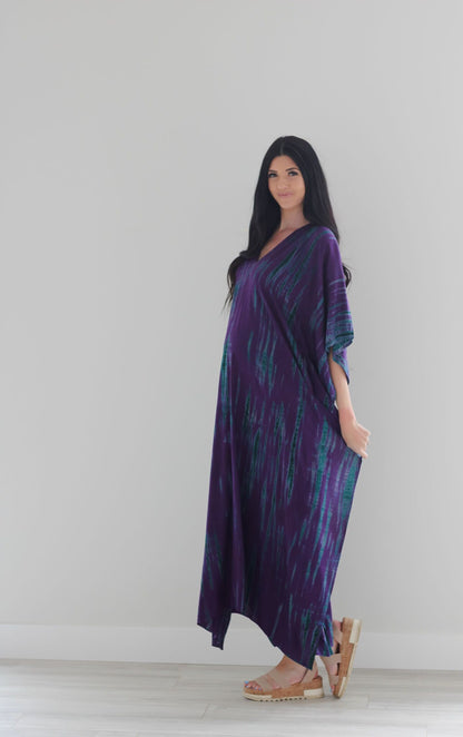 Purple tie-dyed maxi kaftan dress by Erin Pontus, flowing abaya style with vibrant purple and unique dye pattern.