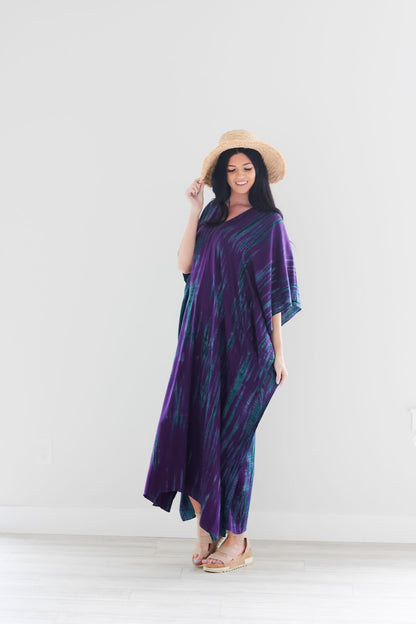 Purple tie-dye maxi kaftan dress by Erin Pontus, flowing abaya style with vibrant purple and unique dye pattern.