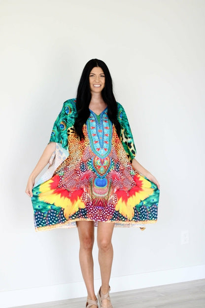 Plus size tropical kaftan dress by Erin Pontus featuring vibrant African-inspired patterns and a midi length style.