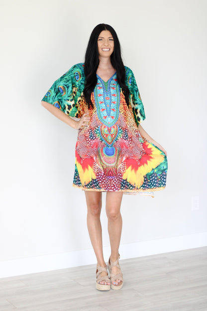 Plus size tropical kaftan dress by Erin Pontus featuring vibrant African-inspired midi design, flowing fabric and colorful patterns.