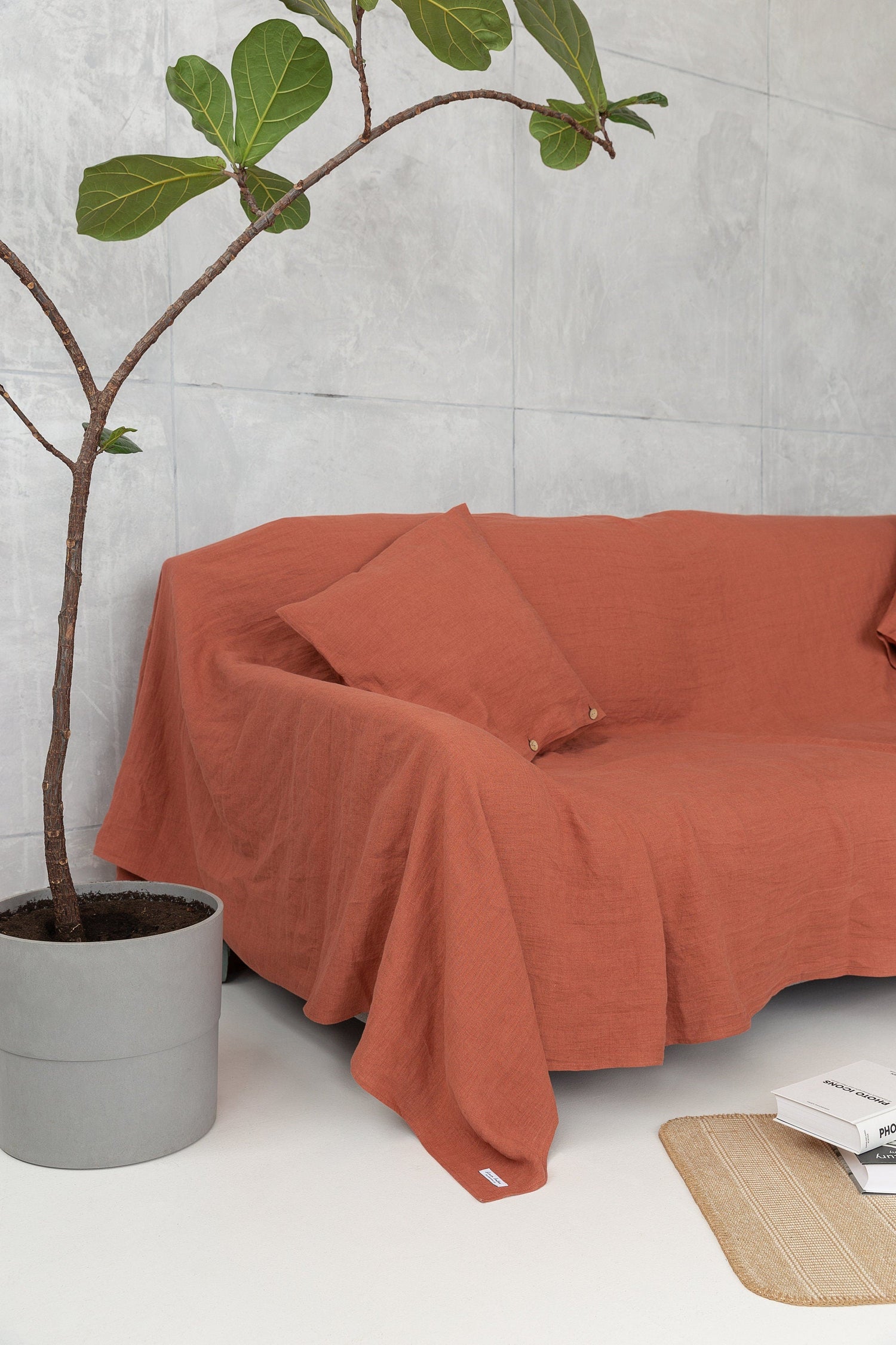 Reddish brown linen couch cover by Magenta Sugarplum, designed to protect and update your living room decor.