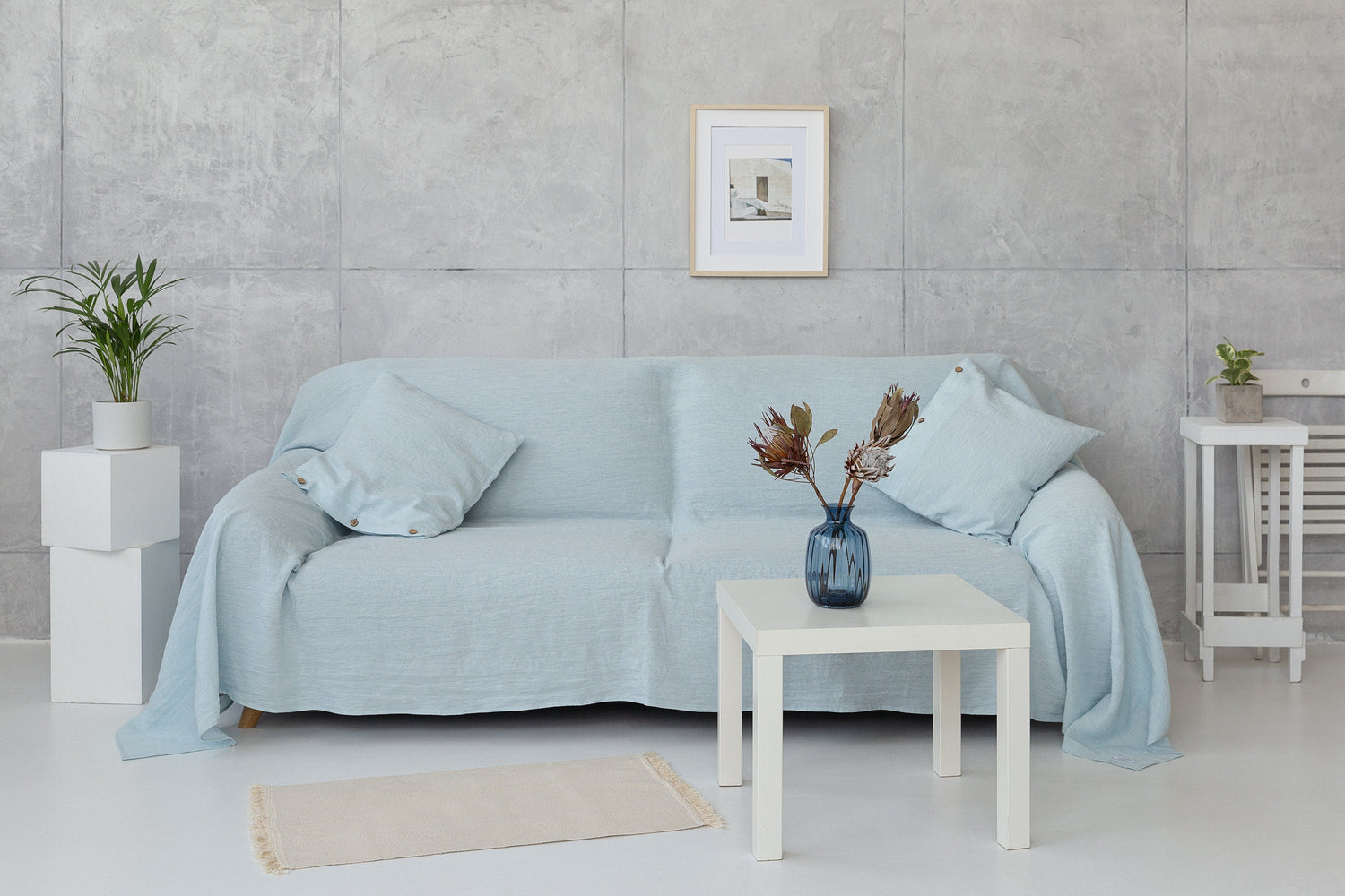 Baby blue linen couch cover by Magenta Sugarplum, showcasing a soft, stylish home decor accent on a sofa.