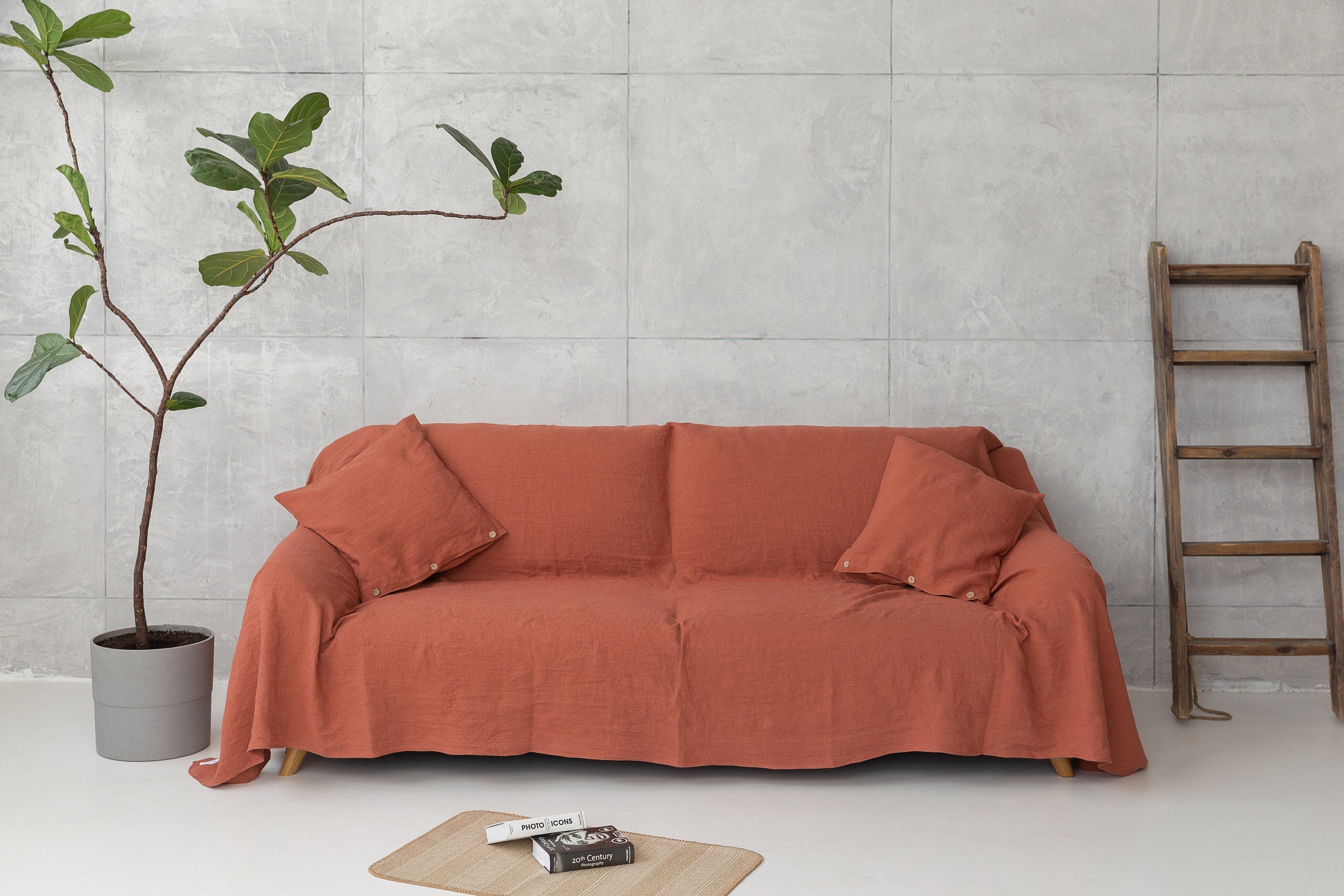 Reddish brown linen couch cover by Magenta Sugarplum, stylish home decor fabric draped over a sofa.