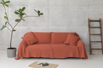 Baby blue linen couch cover by Magenta Sugarplum draped over a sofa, adding a soft and elegant touch to home decor.