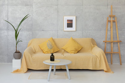 Woodrose linen couch cover by Magenta Sugarplum, soft beige fabric draped over a sofa, enhancing home decor with elegant style.
