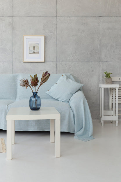 Baby blue linen couch cover by Magenta Sugarplum draped over a sofa, showcasing soft fabric and elegant home decor style.