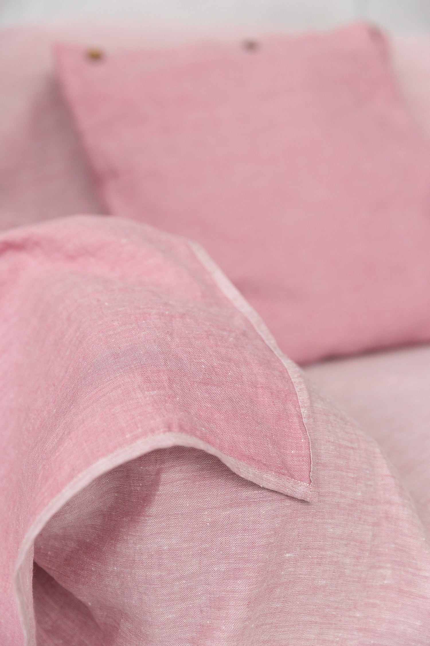 Magenta Sugarplum Woodrose linen couch cover draped over a sofa, showcasing elegant home decor with a soft linen texture.
