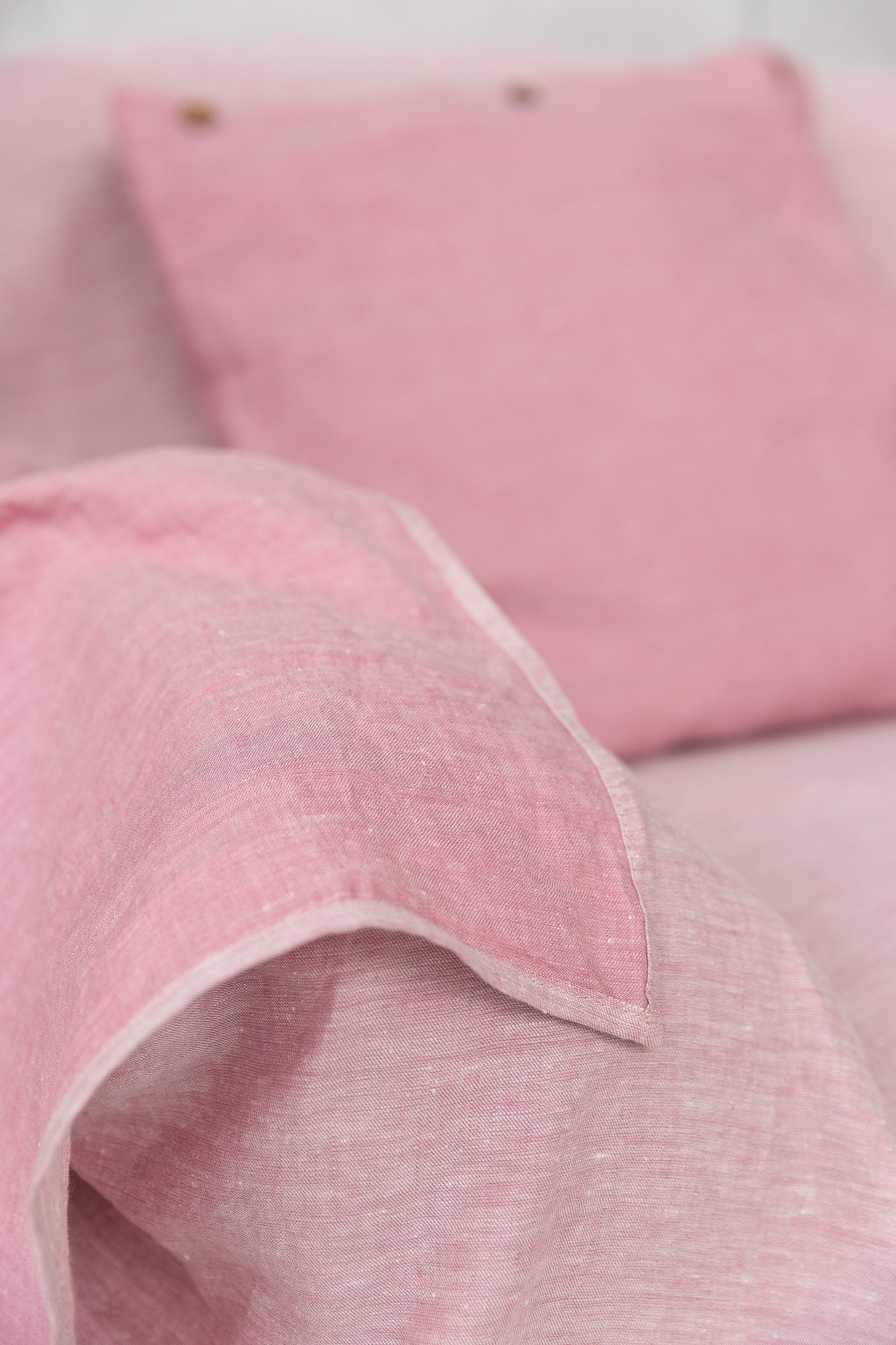 Magenta Sugarplum Woodrose linen couch cover draped over a sofa, showcasing elegant home decor with a soft linen texture.
