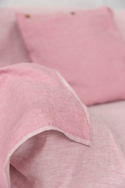 Magenta Sugarplum Woodrose linen couch cover draped over a sofa, showcasing elegant home decor with a soft linen texture.