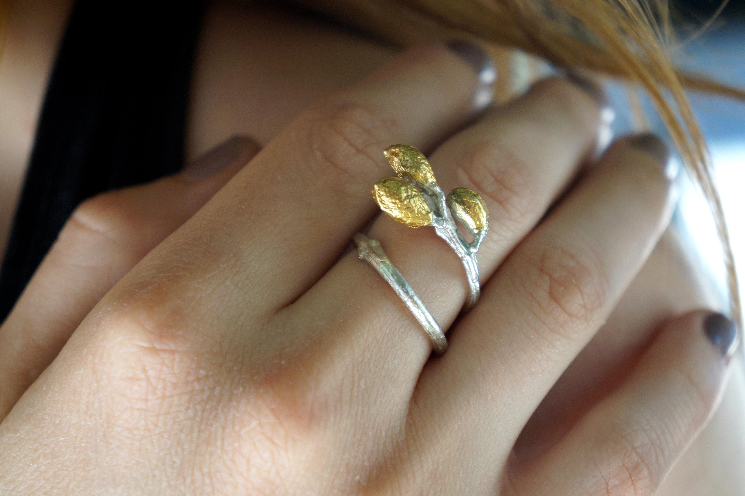 Handmade sterling silver adjustable leaf ring with olive branch design by Beige Briseis, showcasing intricate leaf details.