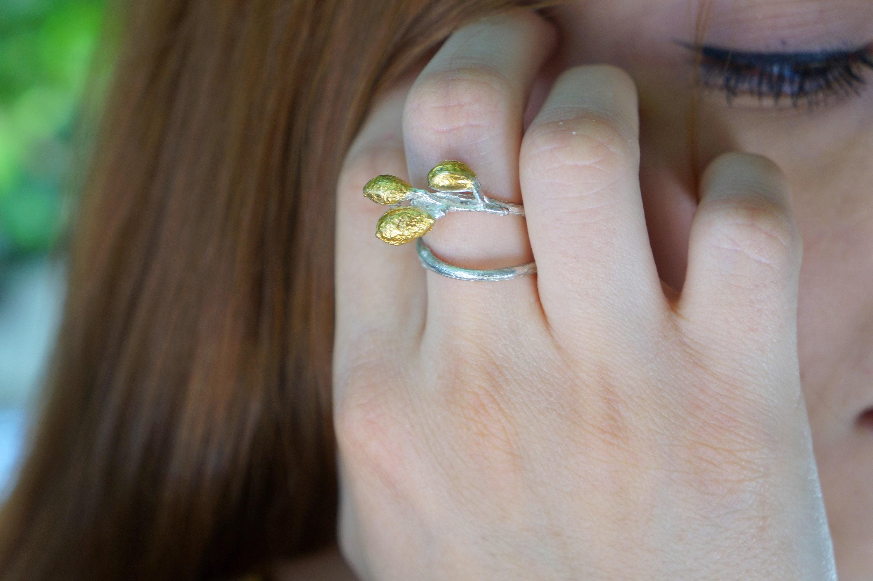 Handmade sterling silver adjustable leaf ring with olive branch design from Beige Briseis, showcasing detailed leaf and branch craftsmanship.