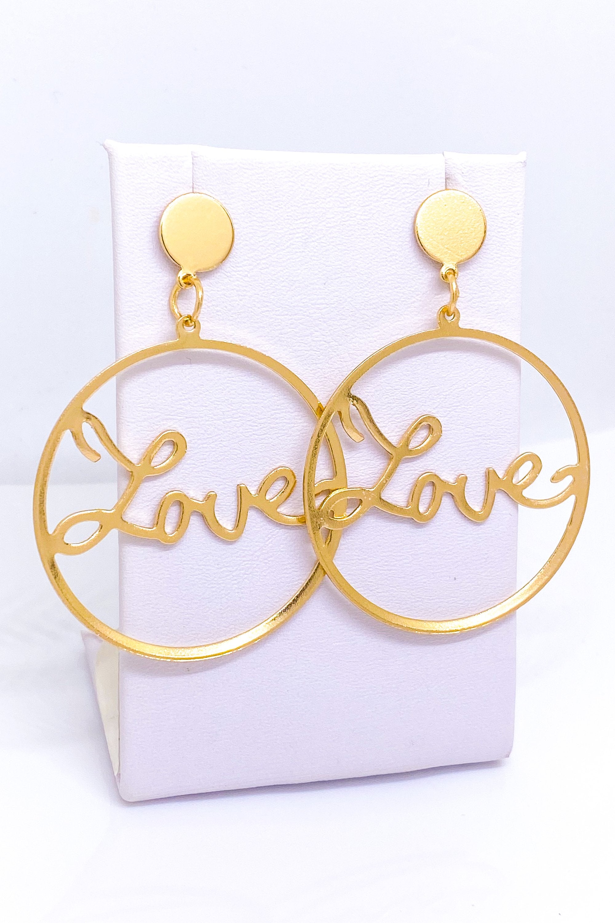 Burgundy Uranus Love Earrings hoops with heart-shaped design, gold-tone metal, and polished finish on a plain white background.