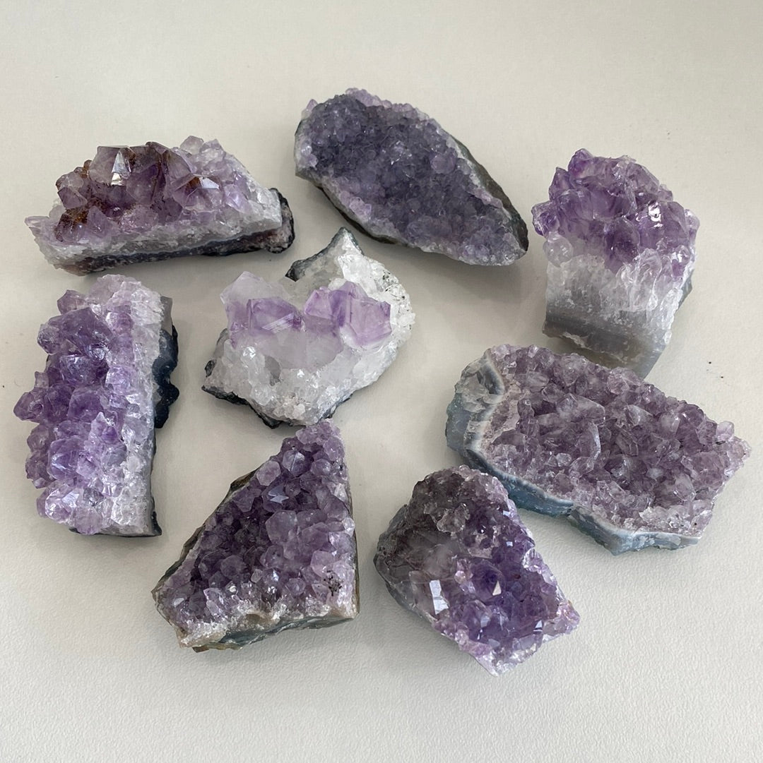 Amethyst clusters for home decor by Taupe Poseidon, featuring vibrant purple crystals arranged as natural mineral formations.