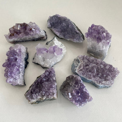 Amethyst clusters for home decor by Taupe Poseidon, featuring vibrant purple crystals arranged as natural mineral formations.