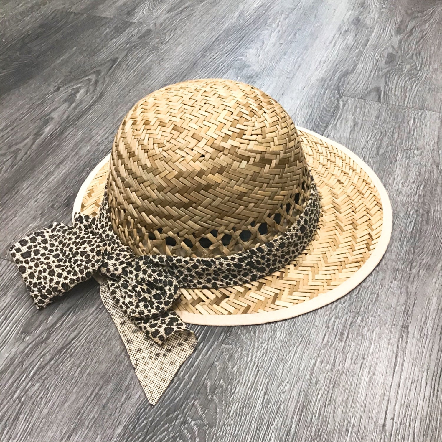 Violet Medea leopard bow straw visor featuring a wide brim and stylish bow detail for sun protection and fashionable outdoor wear
