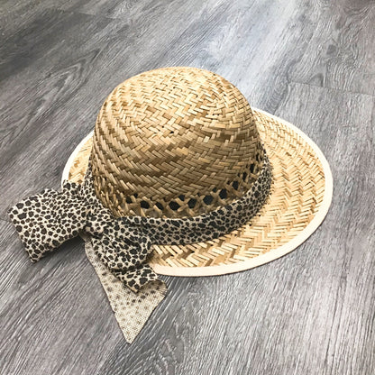 Violet Medea leopard bow straw visor featuring a wide brim and stylish bow detail for sun protection and fashionable outdoor wear