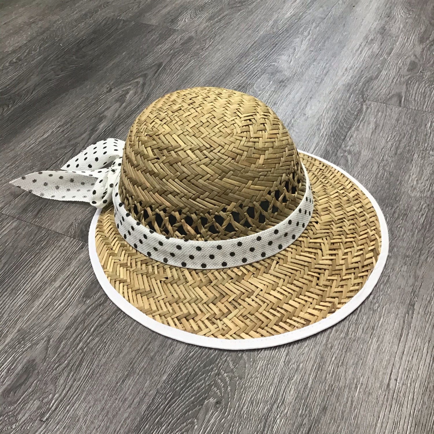 Violet Medea polka dot bow straw visor hat with wide brim and adjustable strap for sun protection and stylish summer wear.