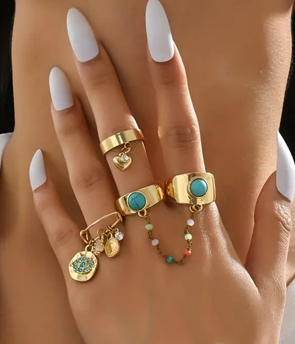 Set of four boho style stackable rings from Purple Windroot featuring mixed metal designs and intricate patterns.