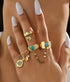 Set of four boho style stackable rings from Purple Windroot featuring mixed metal designs and intricate patterns.