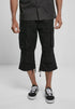 Callisto Industry 3/4 Cargo Shorts with multiple pockets, made from durable fabric, shown in a casual outdoor setting.