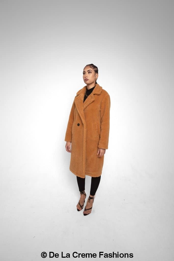 Rose Eleusis Jackie double-breasted borg teddy midi coat displayed on a hanger, showcasing soft fleece exterior and classic coat design.