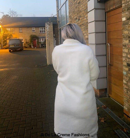 Rose Eleusis Jackie double-breasted borg teddy midi coat, cozy beige jacket with large lapels and button closure.