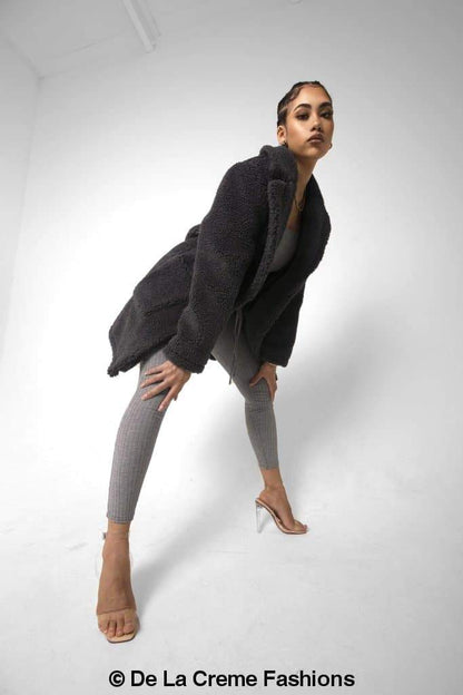 Rose Eleusis Jacqueline oversized teddy coat in beige, soft plush fabric, displayed on a hanger against a neutral background.
