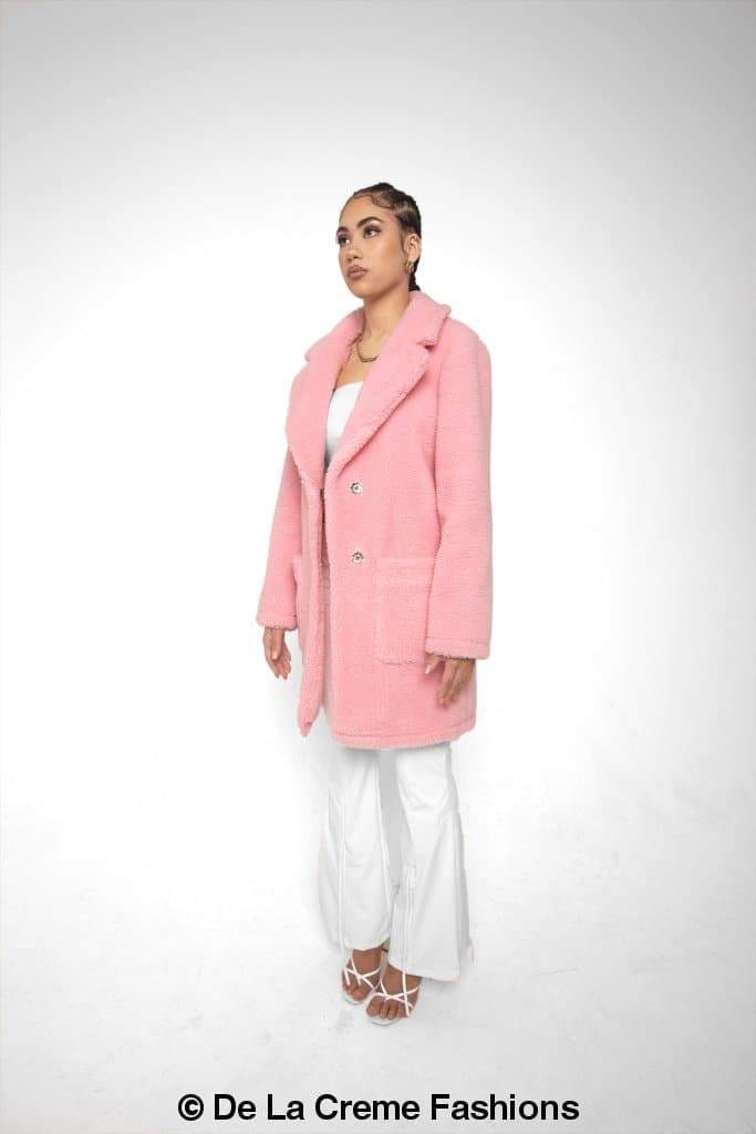 Rose Eleusis Jacqueline oversized teddy coat in soft, plush fabric, shown hanging on a hanger with a cozy, warm appearance.