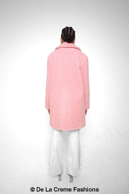 Rose Eleusis Jacqueline oversized teddy coat hanging on a hanger, showcasing its plush, warm, and cozy design with a neutral color.