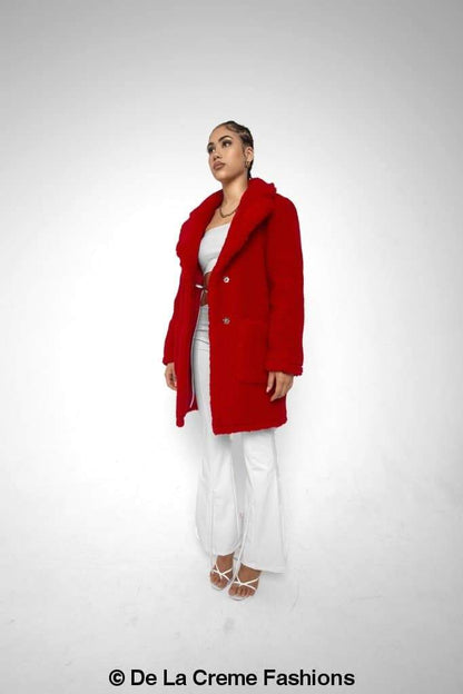 Rose Eleusis Jacqueline oversized teddy coat hanging on a rack, showing its plush, warm fabric and oversized fit.