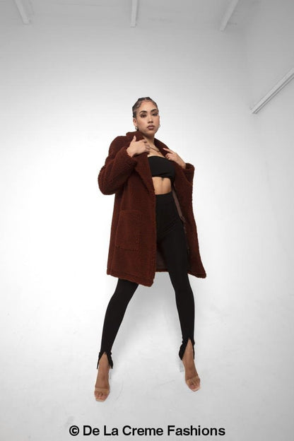 Rose Eleusis Jacqueline oversized teddy coat displayed on a hanger, showcasing plush fabric and relaxed fit in a cozy jacket style.