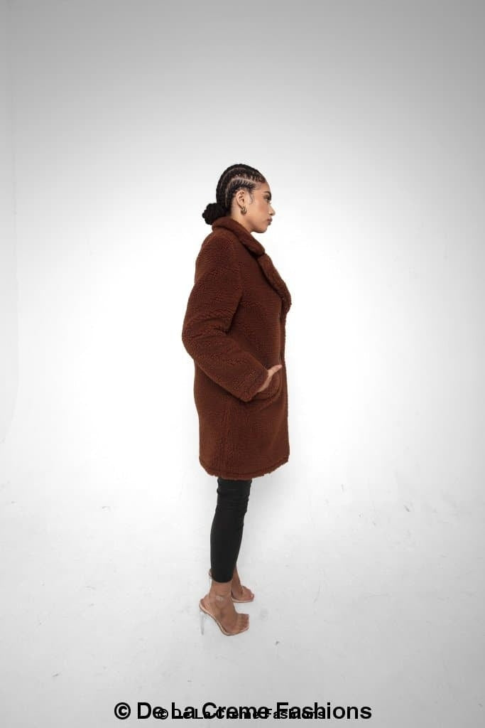 Rose Eleusis Janine double-breasted borg teddy coat, cozy wool-blend jacket with wide lapels and button closure, in a warm neutral tone.