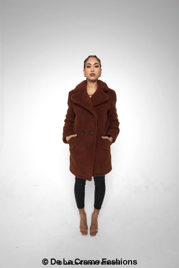 Brown Janine double-breasted borg teddy coat by Rose Eleusis, shown on a model, featuring a cozy, plush exterior and classic coat design.