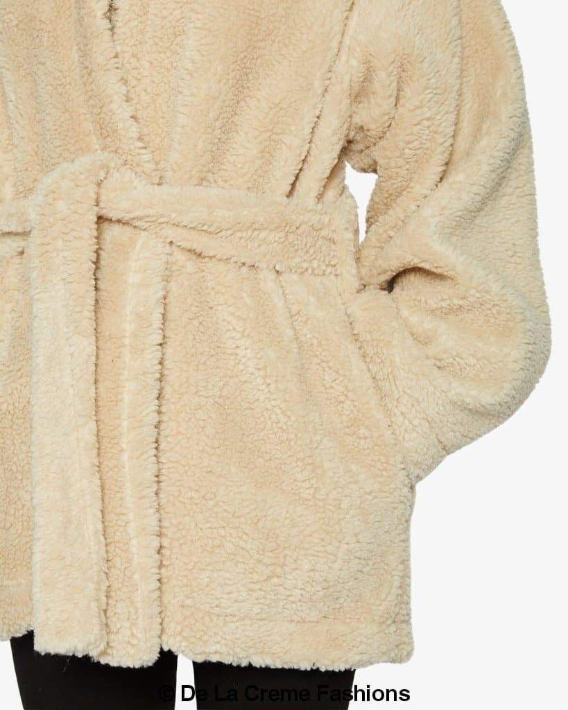 Jenna wearing Rose Eleusis open front belted teddy coat, cozy beige jacket with belt and soft textured fabric.