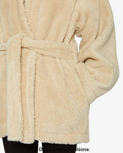 Jenna wearing Rose Eleusis open front belted teddy coat, cozy beige jacket with belt and soft textured fabric.