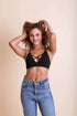 Periwinkle Aether Kali Cross Plunge Bralette in black from the Leto Collection, featuring a plunging design and adjustable straps.
