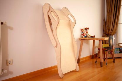 Foldable wooden slide for children, made by Red Oceanus, featuring smooth surfaces and foldable design for easy storage.