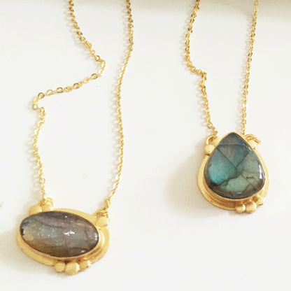 Violet Baobab Agadir Labradorite pendant featuring a polished blue-green labradorite gemstone on a silver chain.