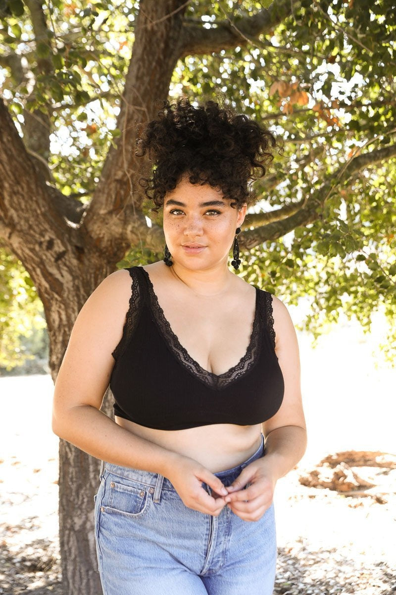 Black lace trim padded bralette by Periwinkle Aether, featuring soft padding and delicate lace details, shown on a white background.