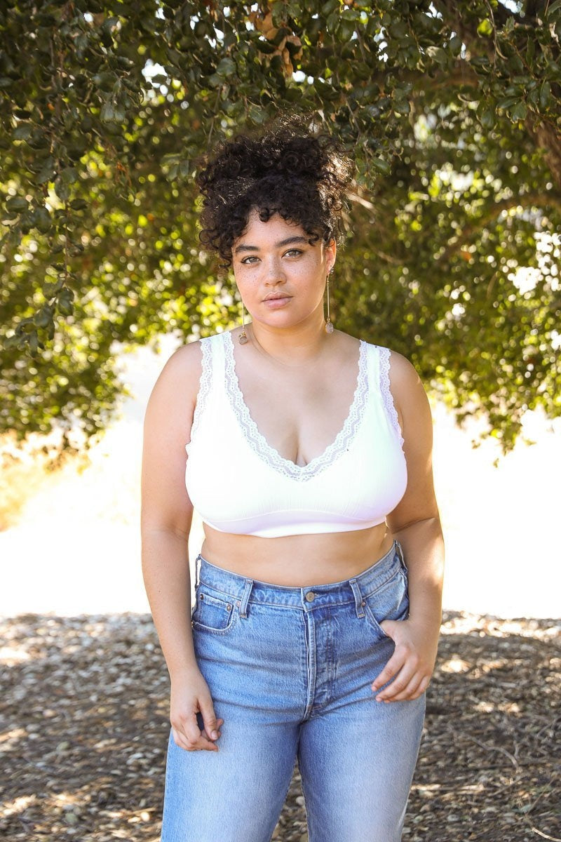 White lace-trim padded bralette from Periwinkle Aether, featuring soft cups and delicate lace details in a comfortable lingerie style.