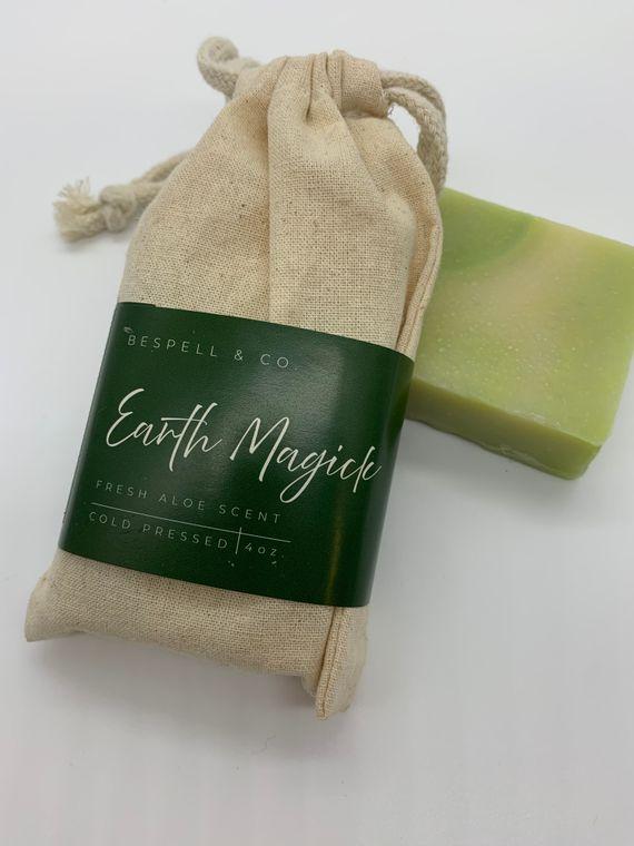 Yellow Coconut Earth Magick Soap accessories, natural soap bar with earthy tones and botanical accents, displayed on a neutral background.