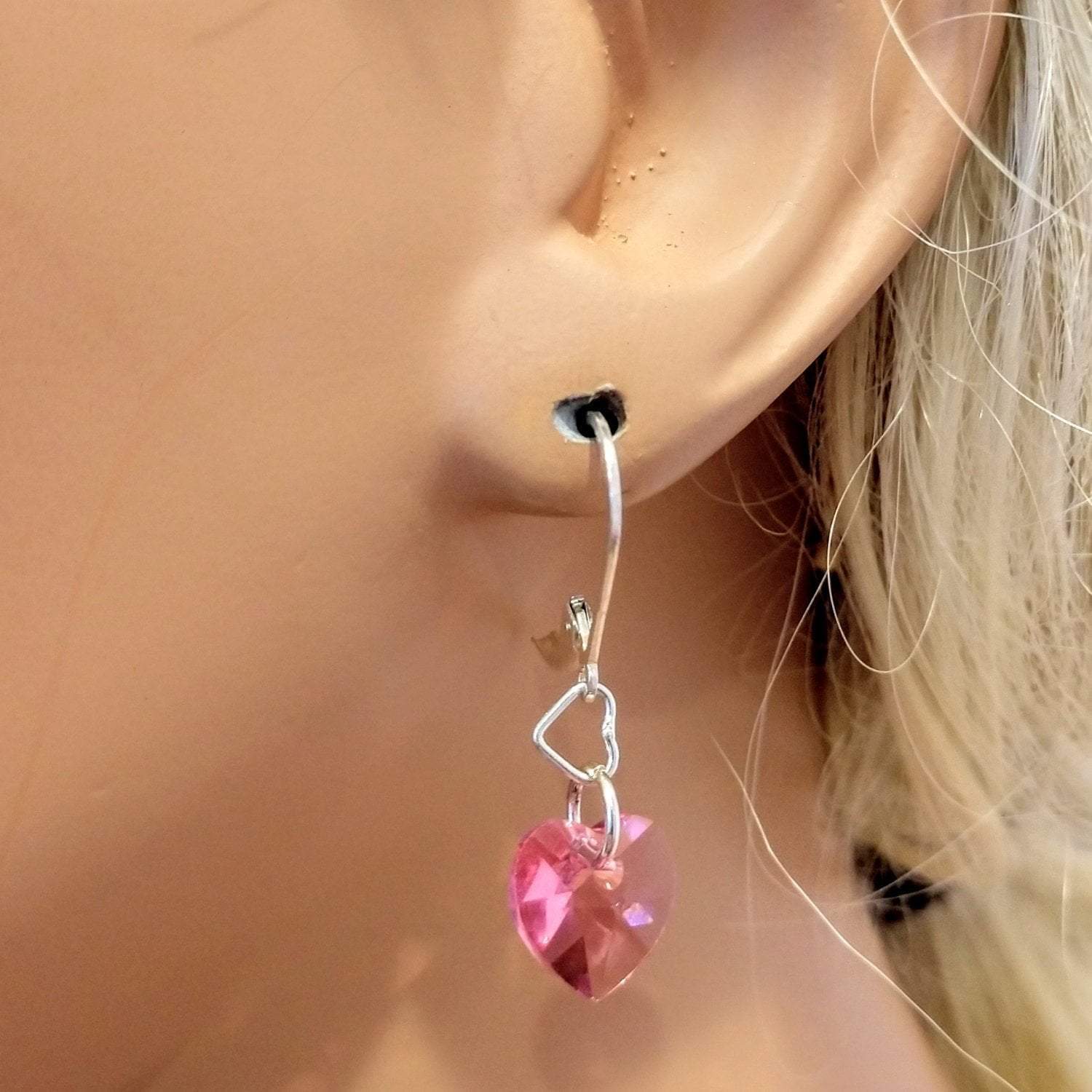 Sterling silver pink crystal heart earrings by Blue Crius featuring delicate heart-shaped design and sparkling pink crystals.