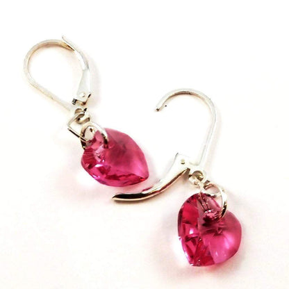 Sterling silver pink crystal heart earrings by Blue Crius, featuring delicate heart-shaped design with sparkling pink crystals.
